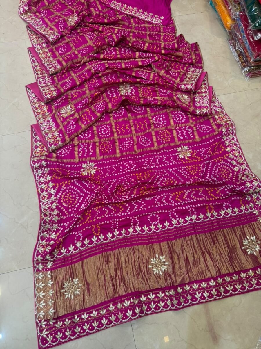 New Arrivals 55 A beautiful fuchsia pink Gajji silk Ghadchola saree with intricate gold Gota Patti handwork displayed on a tile floor.