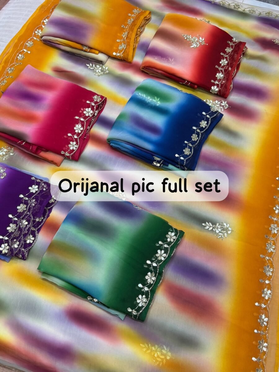 A beautiful collection of multicolored georgette sarees with dabka gota patti work displayed on a table.