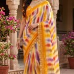 A beautiful collection of multicolored georgette sarees with dabka gota patti work displayed on a table.
