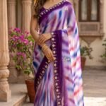 A beautiful collection of multicolored georgette sarees with dabka gota patti work displayed on a table.
