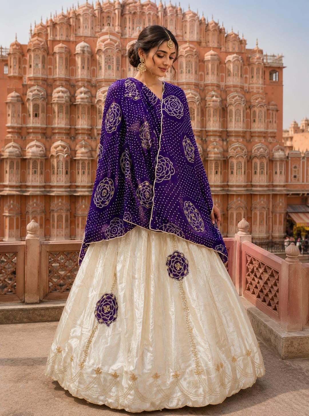 Gota Patti Lehenga in Pure Cosmos Silk 3 A woman wearing a vibrant orange and cream Gota Patti lehenga set stands in front of the Central Museum in Jaipur.