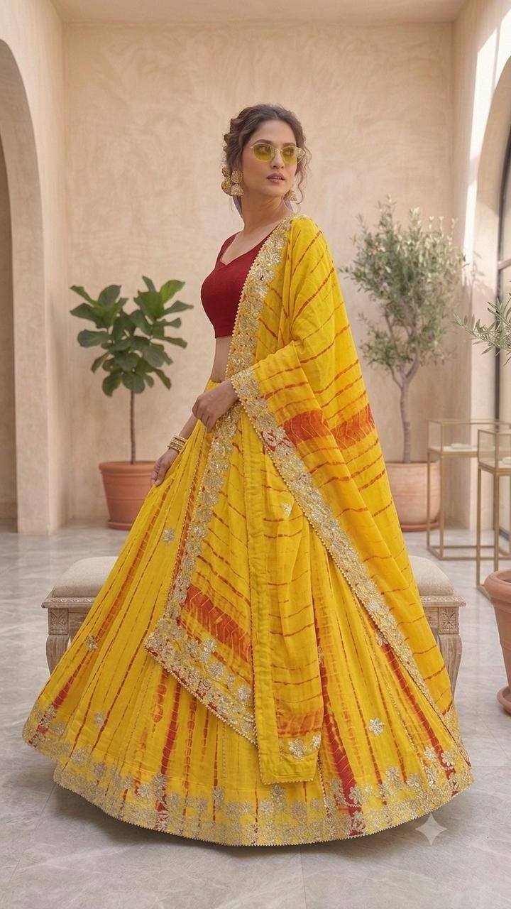Gota Patti Lehenga | Bandhani Lehenga | Jaipuri Lehenga 4 A woman wearing a white and red shibori printed lehenga with heavy Aari Gota Patti work and a matching dupatta.