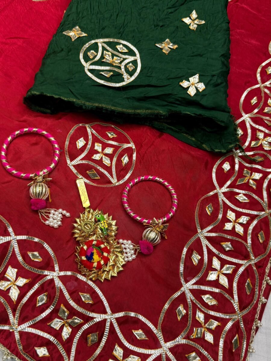 New Arrivals 46 A red pure silk saree with heavy hand-worked Gota Patti borders, accompanied by handmade Kangan and a traditional Kamar Satka.