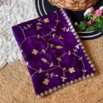 A vibrant purple moss chiffon saree featuring gold gota patti jaal work and a scalloped cutwork border.