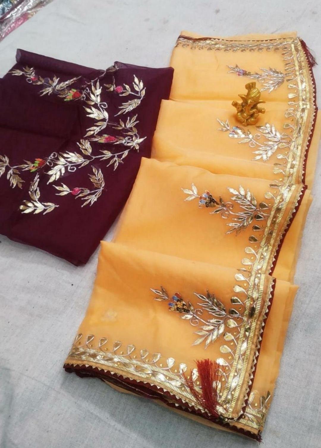 Organza Gota Patti Handwork Saree 4 A beautiful deep purple Organza saree with detailed gold Gota patti handwork and a contrasting bright blue blouse piece.