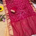 A flat lay of four colorful sarees featuring gold Gota Patti work and Nazbin Jacquard borders arranged on a white fur rug.