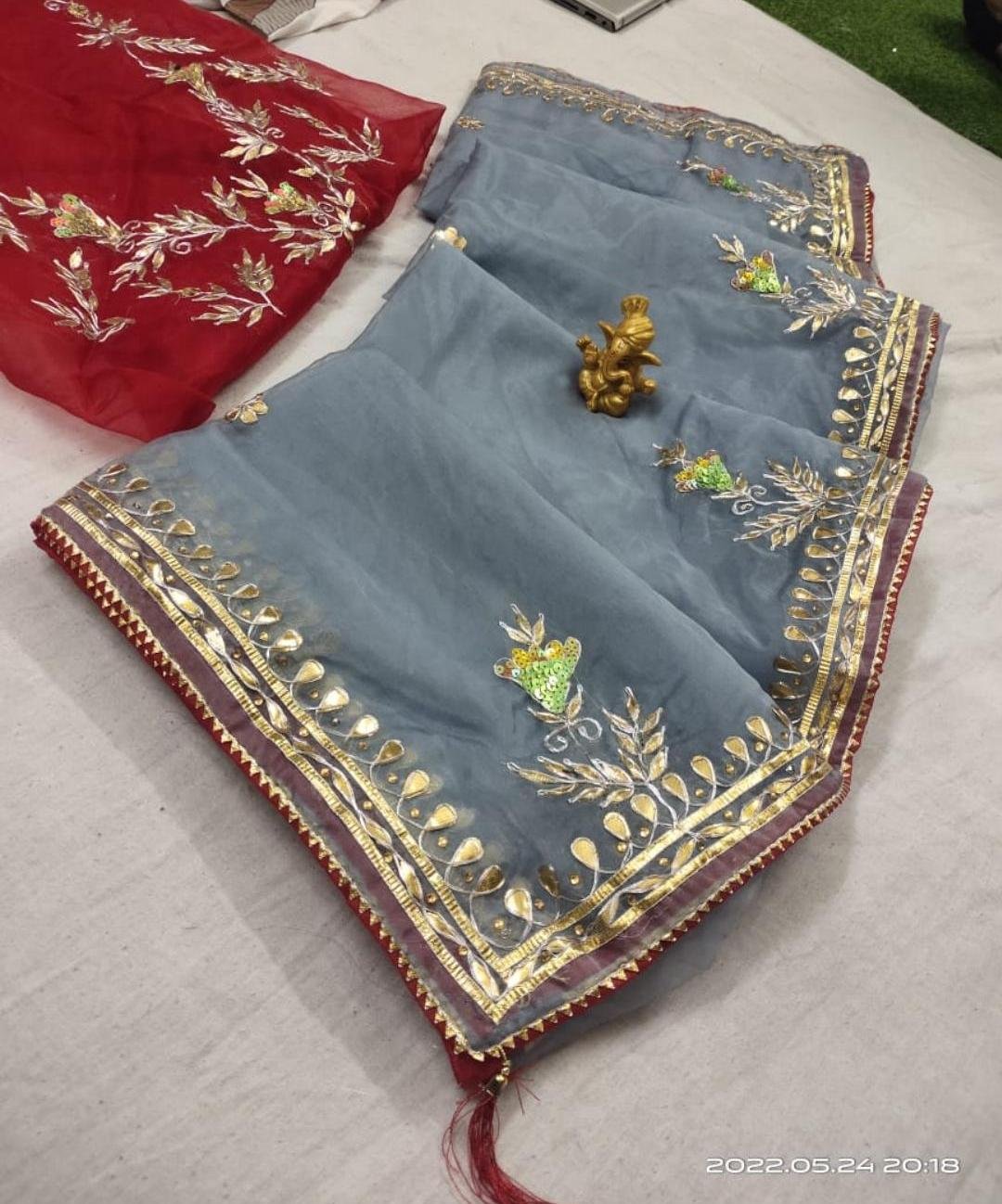 Organza Gota Patti Handwork Saree 6 A beautiful deep purple Organza saree with detailed gold Gota patti handwork and a contrasting bright blue blouse piece.