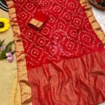 A flat lay of four colorful sarees featuring gold Gota Patti work and Nazbin Jacquard borders arranged on a white fur rug.