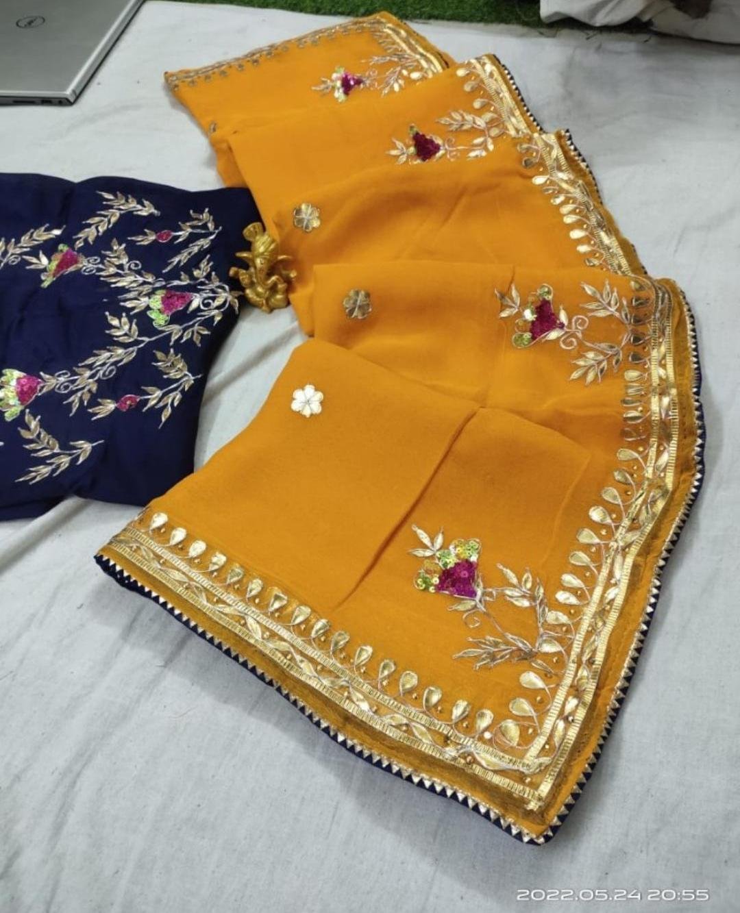 Organza Gota Patti Handwork Saree 7 A beautiful deep purple Organza saree with detailed gold Gota patti handwork and a contrasting bright blue blouse piece.