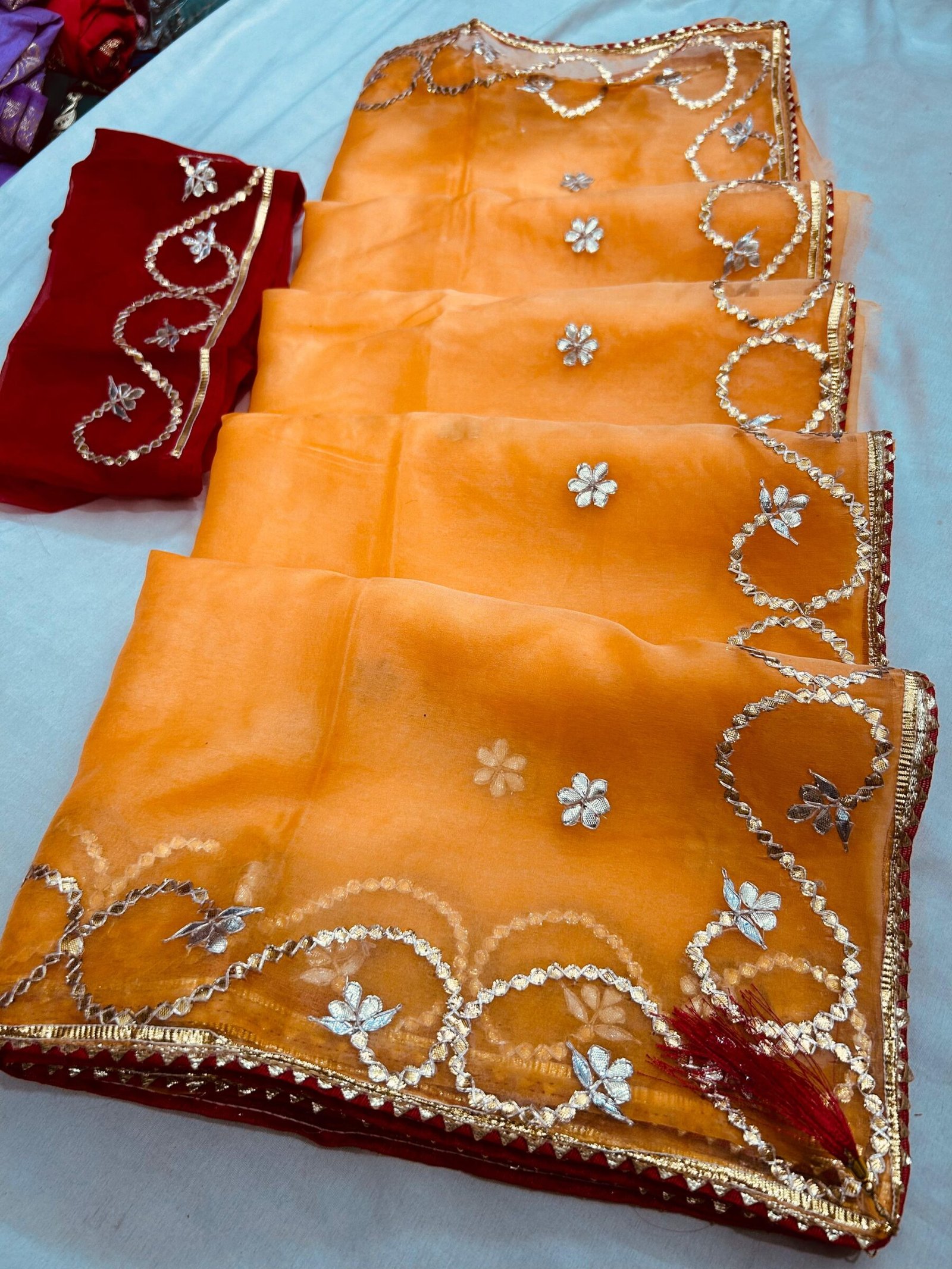 Organza Gota Patti Handwork Saree 9 A beautiful deep purple Organza saree with detailed gold Gota patti handwork and a contrasting bright blue blouse piece.