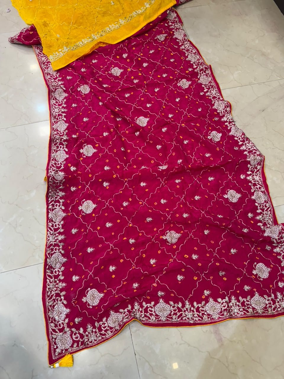 Pure Ho Silk Hand Bandhani Saree with Heavy Embroidery 2 A collection of beautiful Pure Ho silk sarees in vibrant colors featuring hand Bandhani work and intricate heavy embroidery.