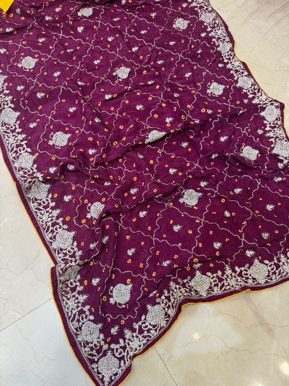 Pure Ho Silk Hand Bandhani Saree with Heavy Embroidery 3 A collection of beautiful Pure Ho silk sarees in vibrant colors featuring hand Bandhani work and intricate heavy embroidery.