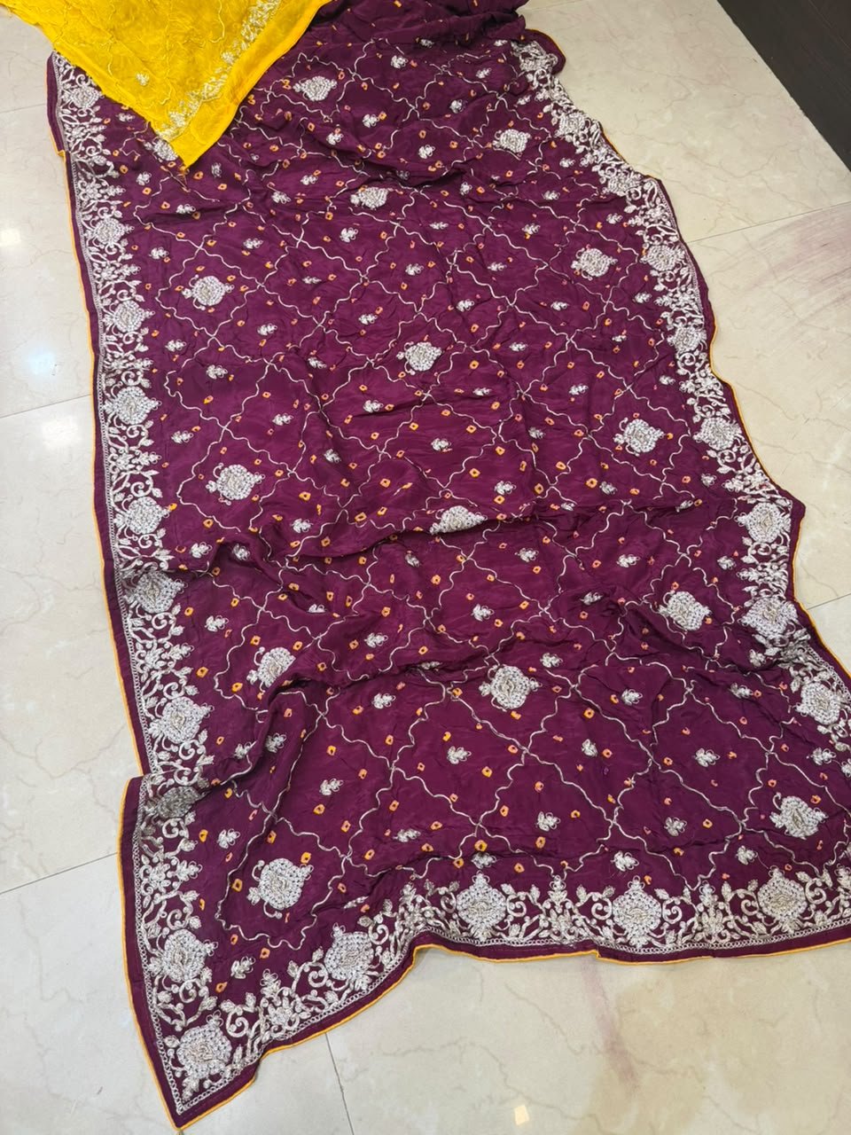 Pure Ho Silk Hand Bandhani Saree with Heavy Embroidery 6 A collection of beautiful Pure Ho silk sarees in vibrant colors featuring hand Bandhani work and intricate heavy embroidery.