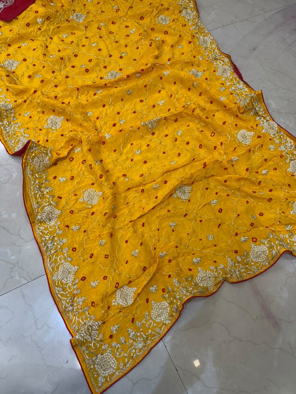 Pure Ho Silk Hand Bandhani Saree with Heavy Embroidery 7 A collection of beautiful Pure Ho silk sarees in vibrant colors featuring hand Bandhani work and intricate heavy embroidery.
