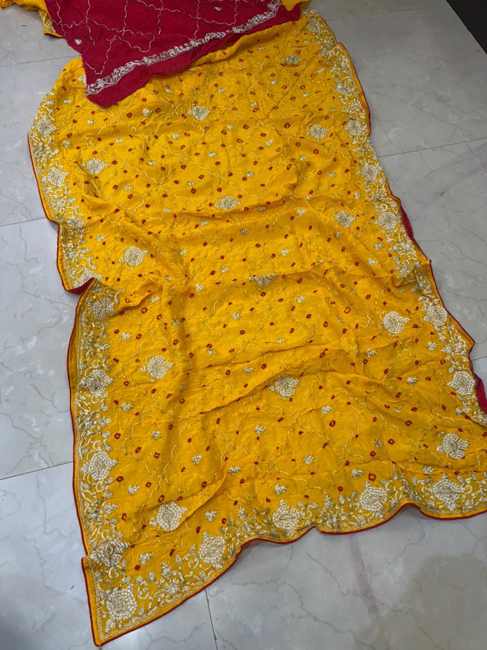 Pure Ho Silk Hand Bandhani Saree with Heavy Embroidery 8 A collection of beautiful Pure Ho silk sarees in vibrant colors featuring hand Bandhani work and intricate heavy embroidery.