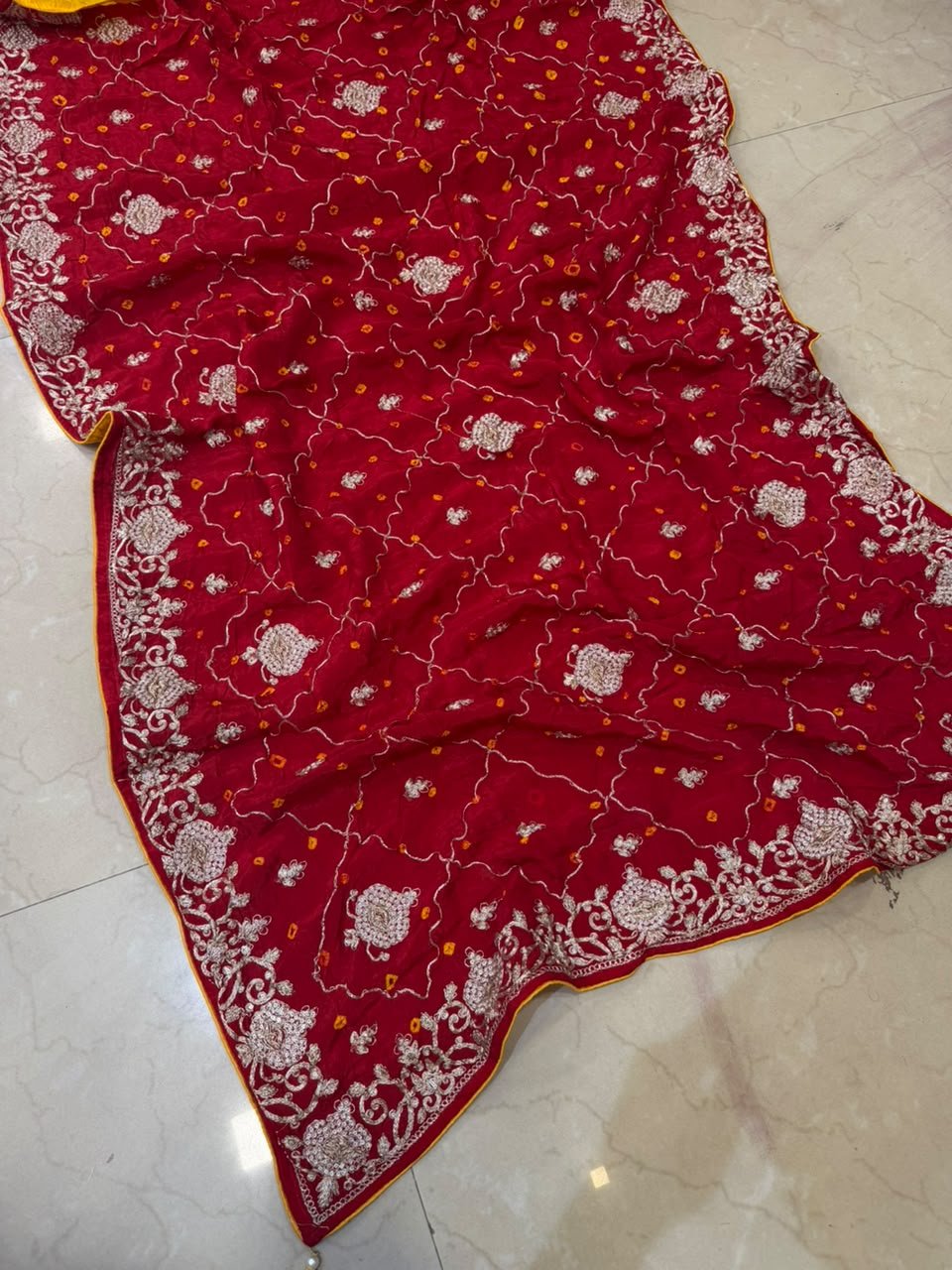 Pure Ho Silk Hand Bandhani Saree with Heavy Embroidery 9 A collection of beautiful Pure Ho silk sarees in vibrant colors featuring hand Bandhani work and intricate heavy embroidery.