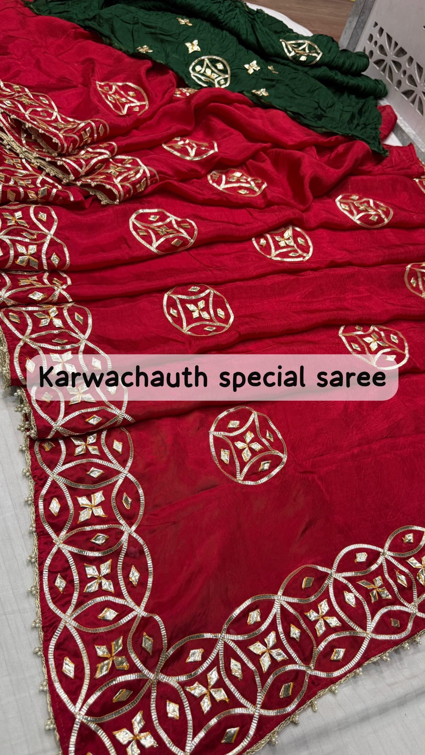 Super Duper Karwachauth Special HO Silk Gota Patti Saree 4 A beautiful red Karwachauth special saree with intricate green and gold Kachhi Gota Patti work, paired with matching bangles and a Kamar satka.