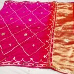 A vibrant pink and orange Jaipuri silk saree with gold gota patti diamond patterns and a rich golden border.