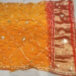 A vibrant pink and orange Jaipuri silk saree with gold gota patti diamond patterns and a rich golden border.