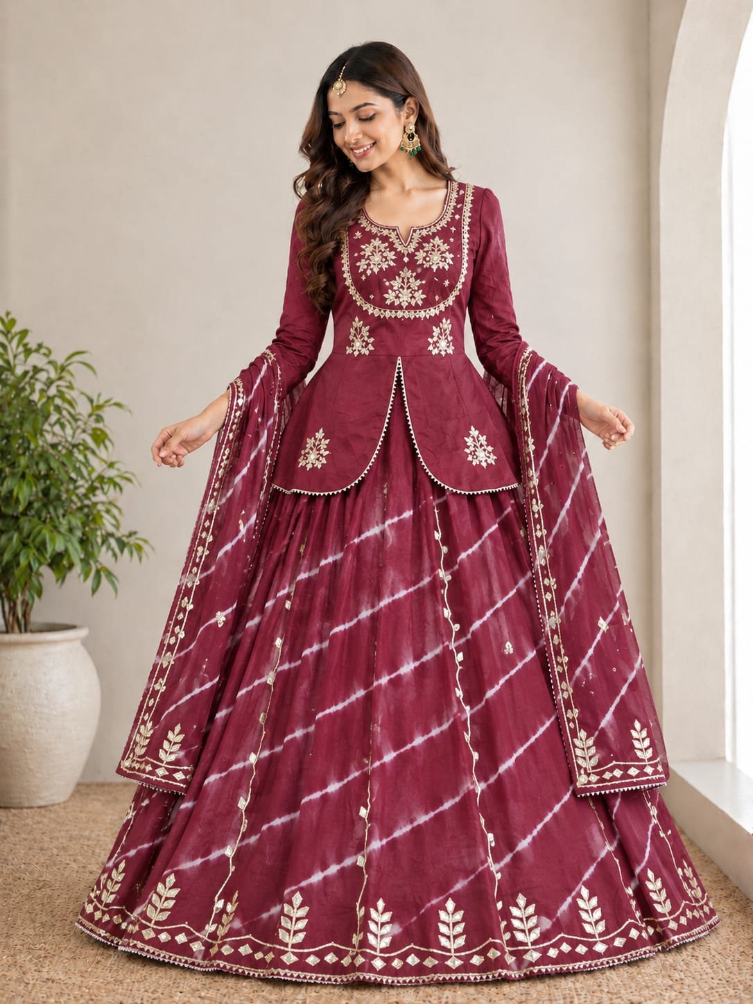Jaipuri Lehenga with Gota Patti Work in Chinon Silk 2 A woman posing in a blue and sky blue tie-dye pattern Chinon silk lehenga set with intricate Gota Patti handwork on a peplum blouse.