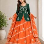 A woman posing in a blue and sky blue tie-dye pattern Chinon silk lehenga set with intricate Gota Patti handwork on a peplum blouse.