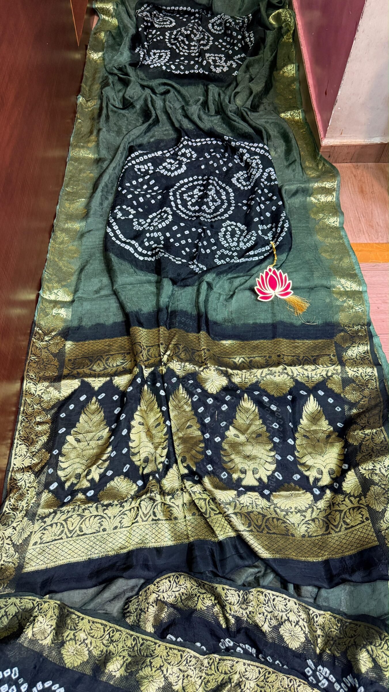 Pure Jamnagari Silk Bandhej Saree with Zari Border 2 A vibrant orange Pure Jamnagari Silk Bandhej saree with intricate golden zari border and a hand-woven zari pallu.