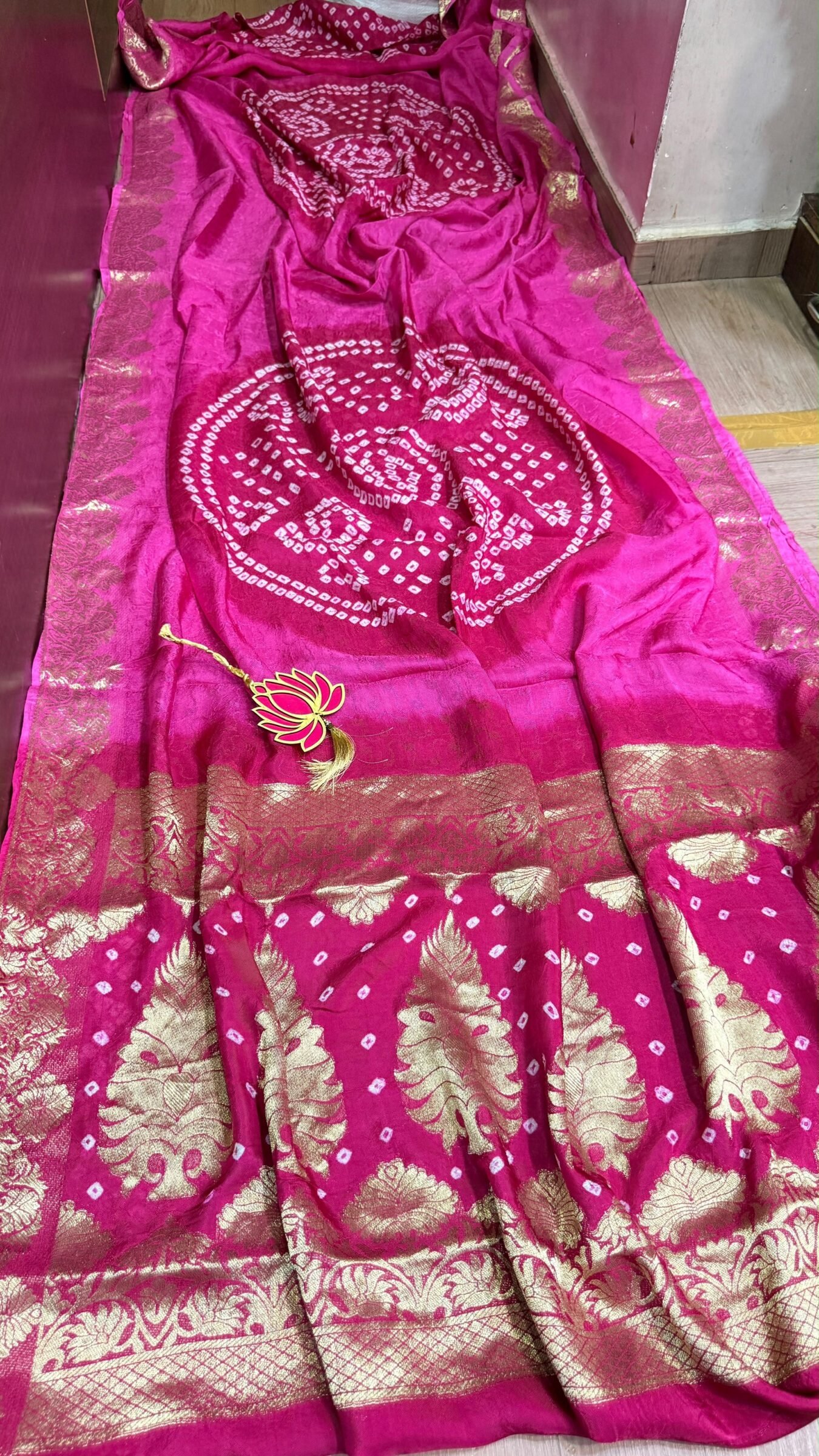 Pure Jamnagari Silk Bandhej Saree with Zari Border 4 A vibrant orange Pure Jamnagari Silk Bandhej saree with intricate golden zari border and a hand-woven zari pallu.