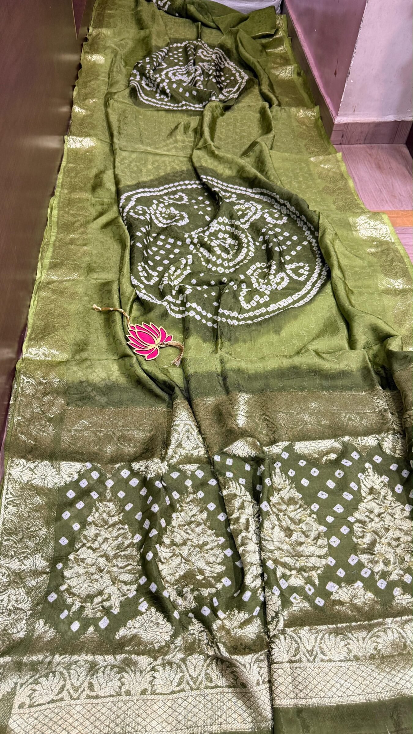 Pure Jamnagari Silk Bandhej Saree with Zari Border 5 A vibrant orange Pure Jamnagari Silk Bandhej saree with intricate golden zari border and a hand-woven zari pallu.