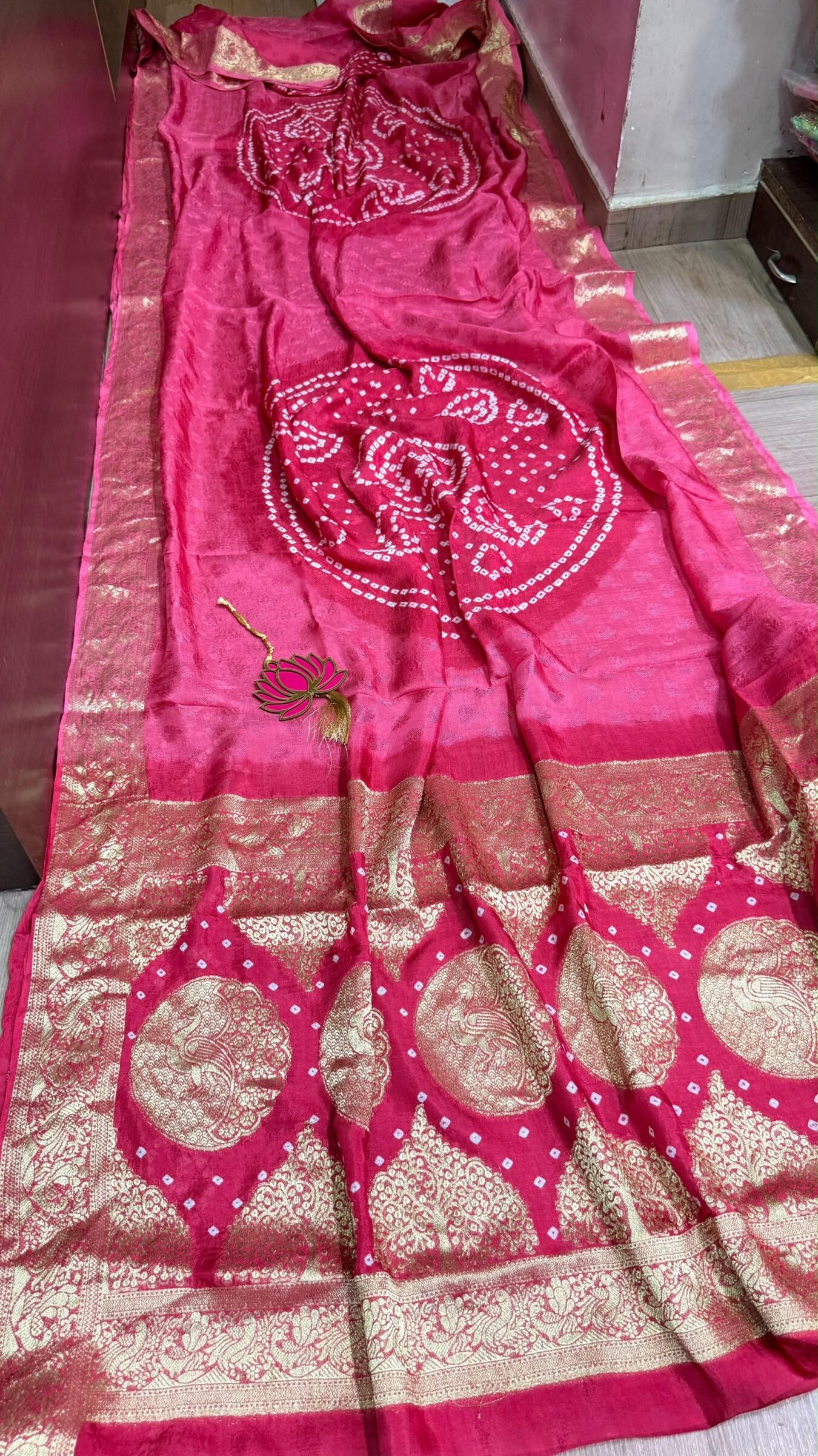 Pure Jamnagari Silk Bandhej Saree with Zari Border 6 A vibrant orange Pure Jamnagari Silk Bandhej saree with intricate golden zari border and a hand-woven zari pallu.
