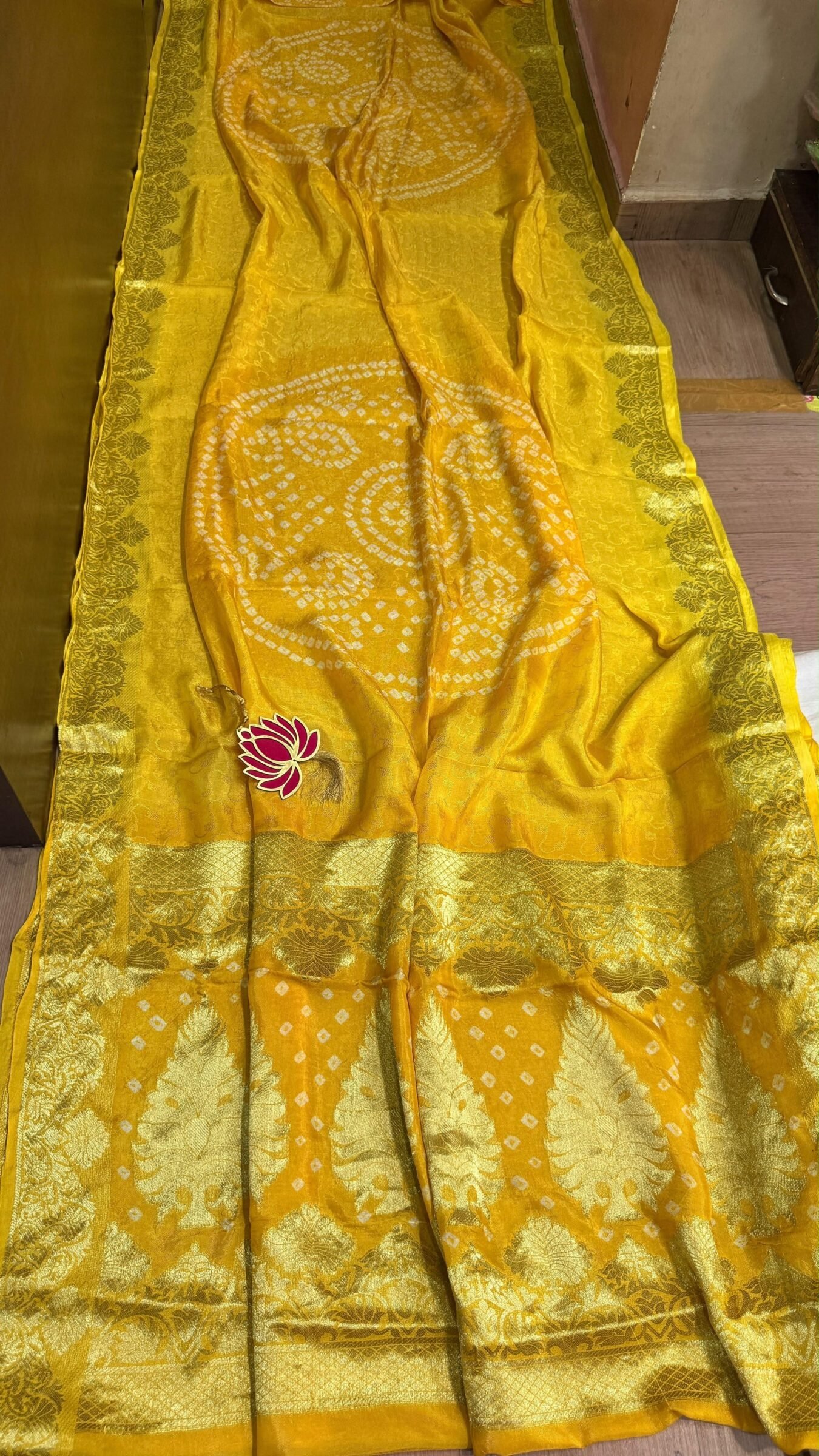 Pure Jamnagari Silk Bandhej Saree with Zari Border 7 A vibrant orange Pure Jamnagari Silk Bandhej saree with intricate golden zari border and a hand-woven zari pallu.