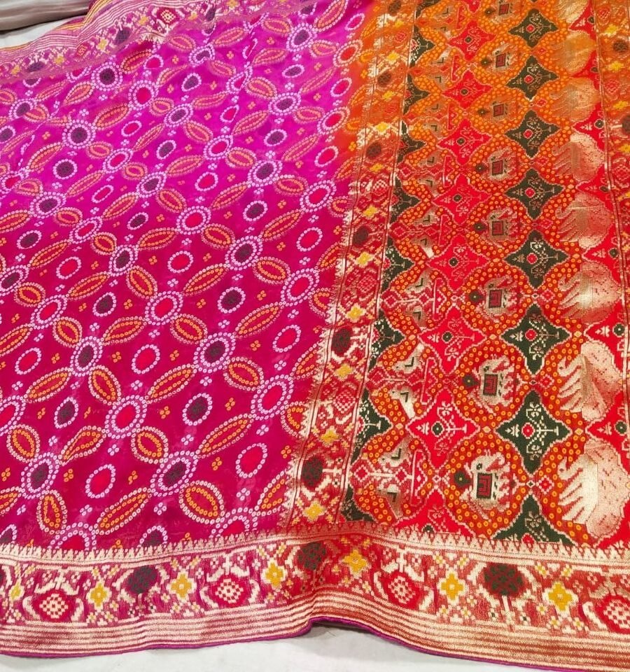 A close-up of a pink and orange Pure Khadi Jhorjhat Banarashi Bandhej saree with heavy zari and meena work.