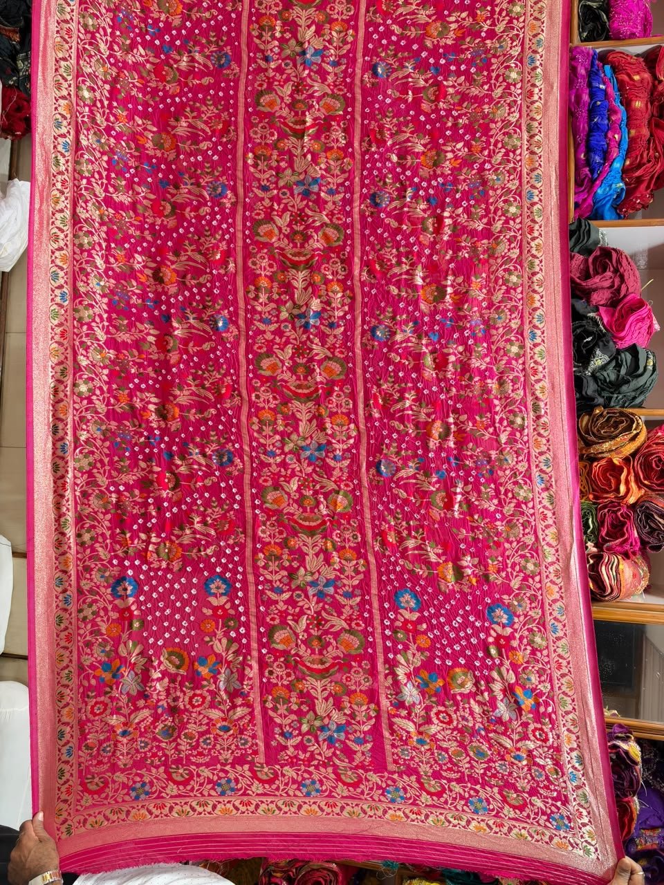 Pure Handloom Khadi Silk Neemjari Bandhej Saree 1 A beautiful deep pink pure Khadi Silk saree featuring intricate Bandhej patterns and detailed gold Neemjari border work.