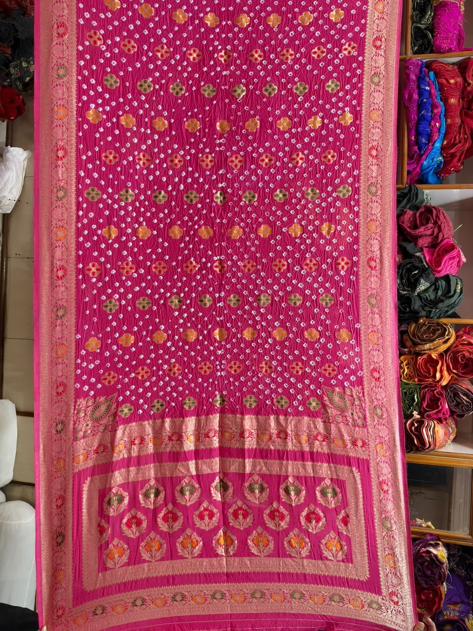 Pure Handloom Khadi Silk Neemjari Bandhej Saree 4 A beautiful deep pink pure Khadi Silk saree featuring intricate Bandhej patterns and detailed gold Neemjari border work.