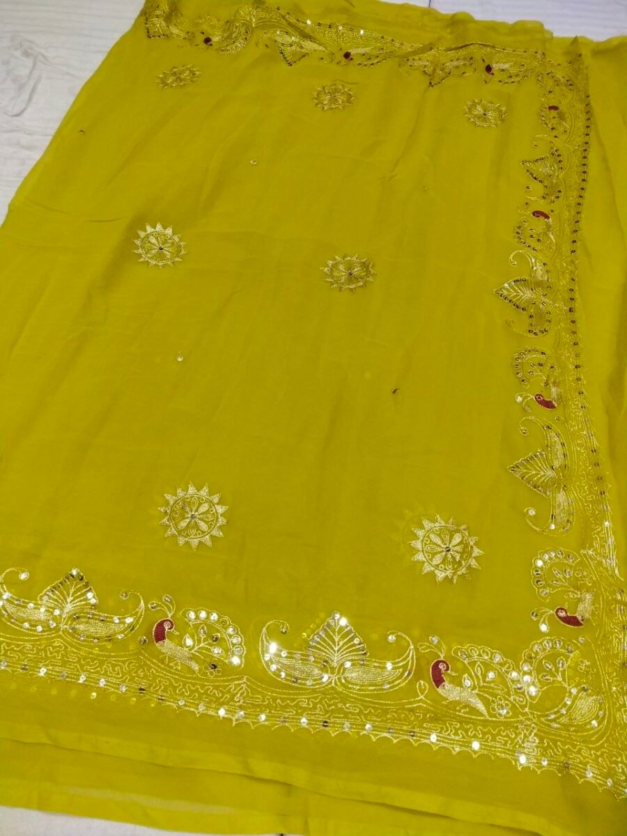 A bright yellow pure 30g Georgette saree with aari machine work and mirror embellishments along the border and fabric.