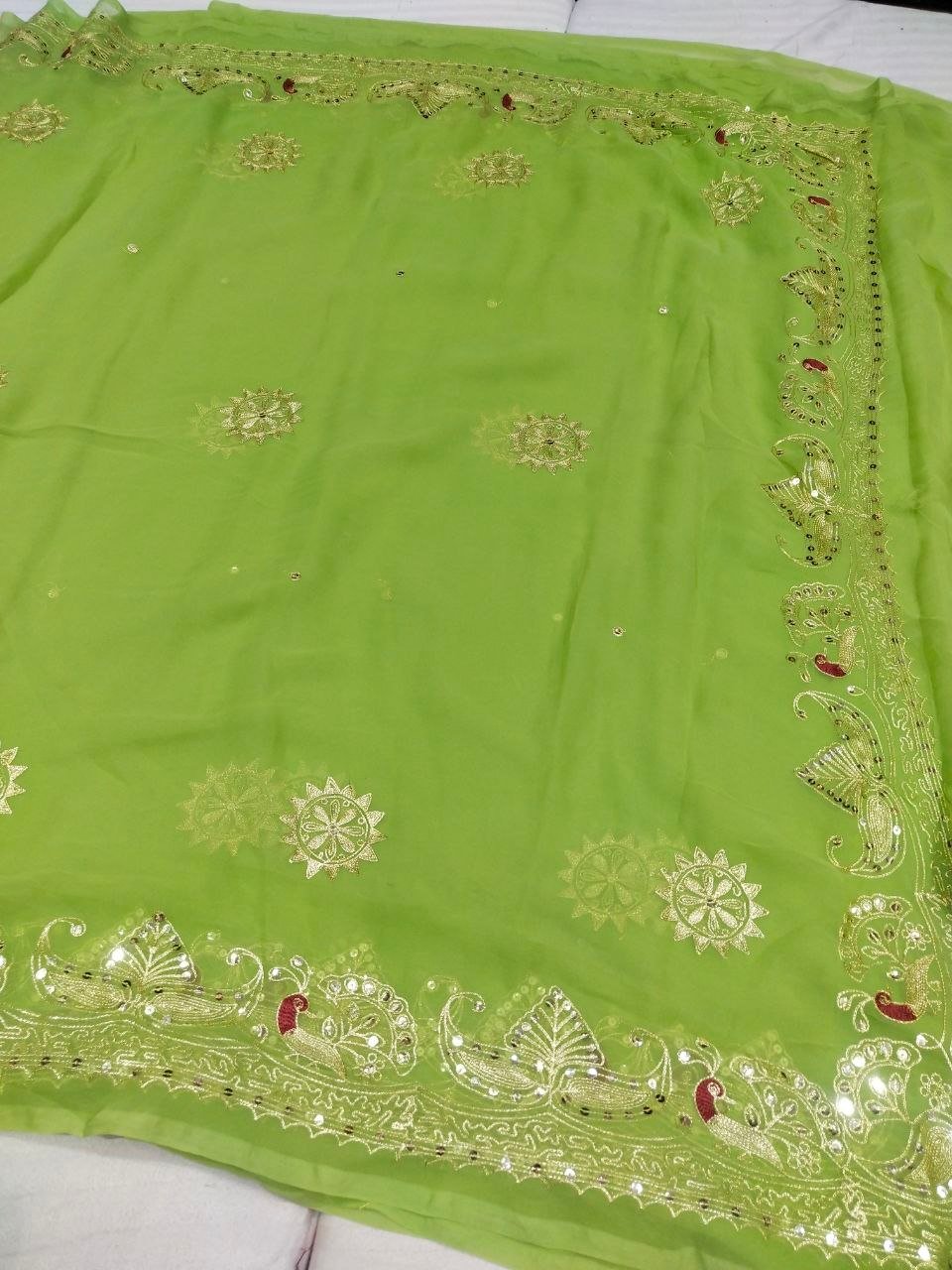 Mirror Work Saree in Pure Georgette with Aari Machine Work 2 A bright yellow pure 30g Georgette saree with aari machine work and mirror embellishments along the border and fabric.
