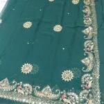 A bright yellow pure 30g Georgette saree with aari machine work and mirror embellishments along the border and fabric.