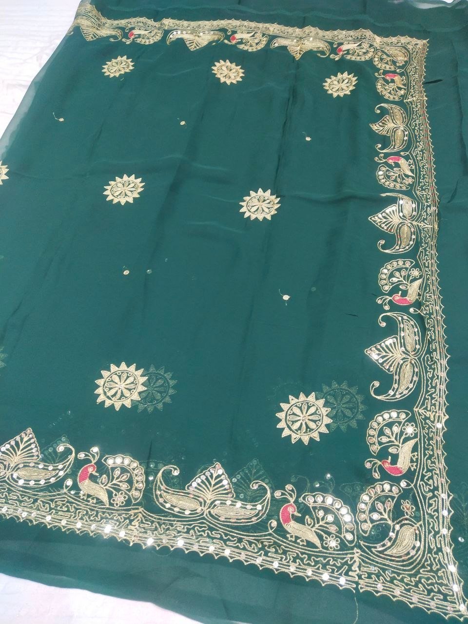 Mirror Work Saree in Pure Georgette with Aari Machine Work 3 A bright yellow pure 30g Georgette saree with aari machine work and mirror embellishments along the border and fabric.
