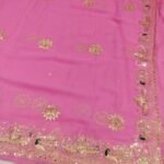 A bright yellow pure 30g Georgette saree with aari machine work and mirror embellishments along the border and fabric.