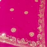 A bright yellow pure 30g Georgette saree with aari machine work and mirror embellishments along the border and fabric.