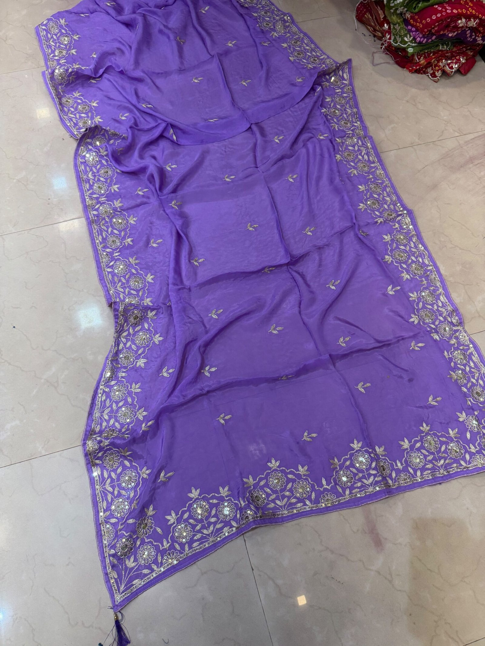 Pure Ho Silk Saree with Elegant Handwork | Kanha Saree 10 A beautiful purple Pure Ho silk saree adorned with delicate gold handwork embroidery along the borders and on the body.