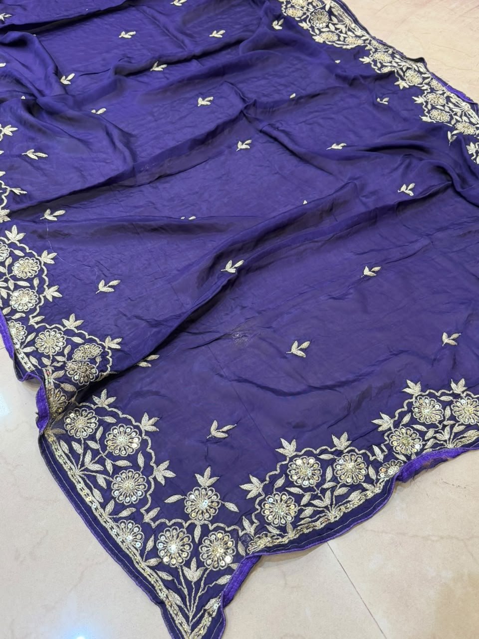 Pure Ho Silk Saree with Elegant Handwork | Kanha Saree 5 A beautiful purple Pure Ho silk saree adorned with delicate gold handwork embroidery along the borders and on the body.