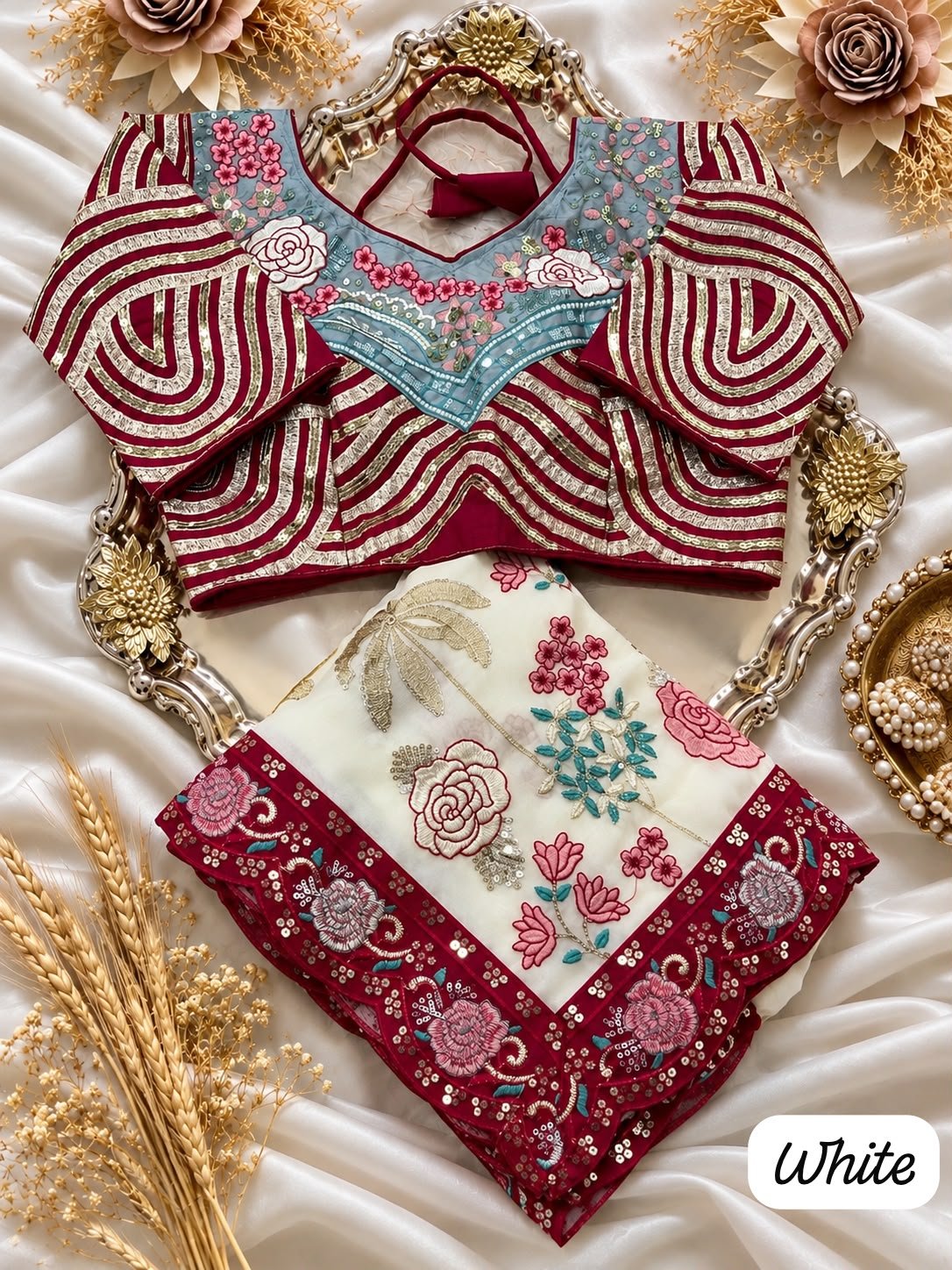 Premium Rangoli Silk Saree with Fully Stitched Blouse 1 A beautiful white and maroon Rangoli Silk saree displayed with a heavy embroidered stitched blouse on a silver tray.