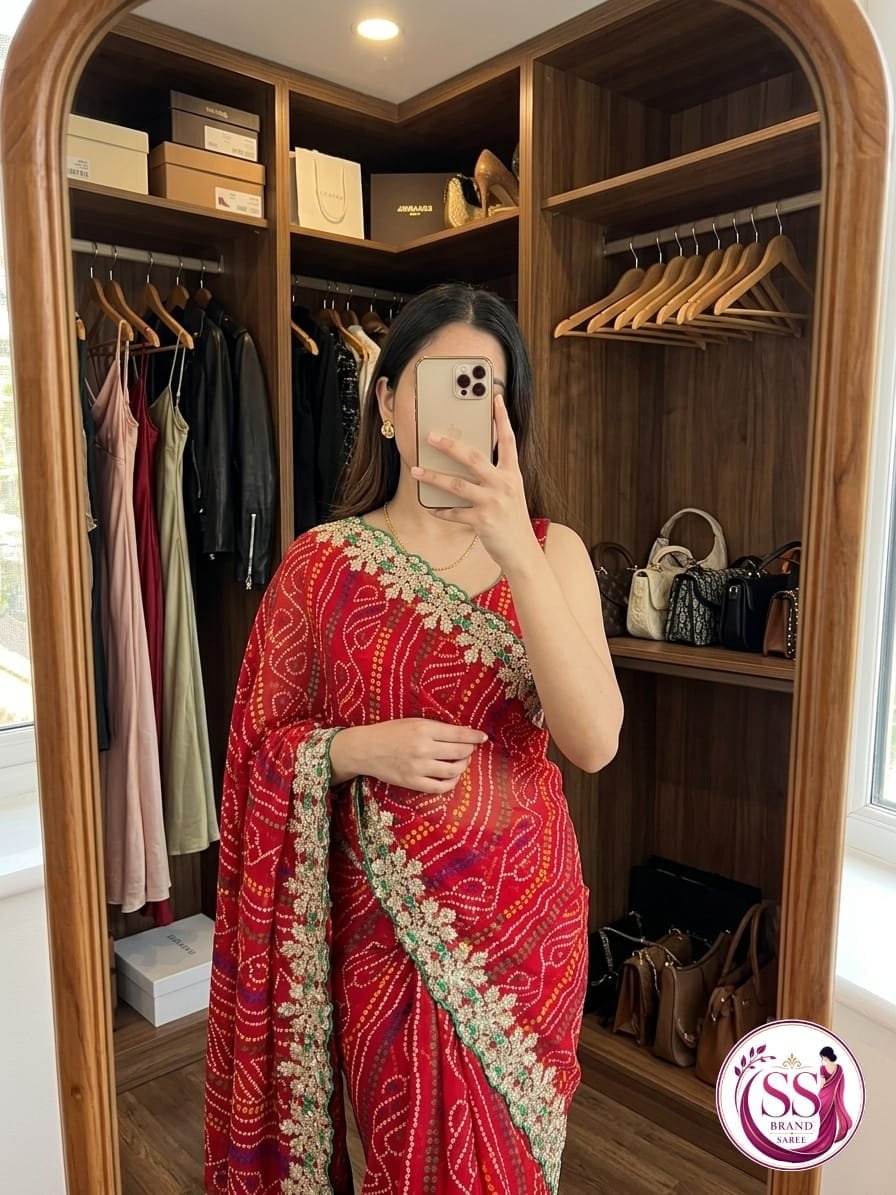 Russian Crepe Silk Saree with Gota Patti and Sequence Work 5 A woman wearing a vibrant orange and pink Russian crepe silk saree with elegant gota lace border and sequence embroidery.