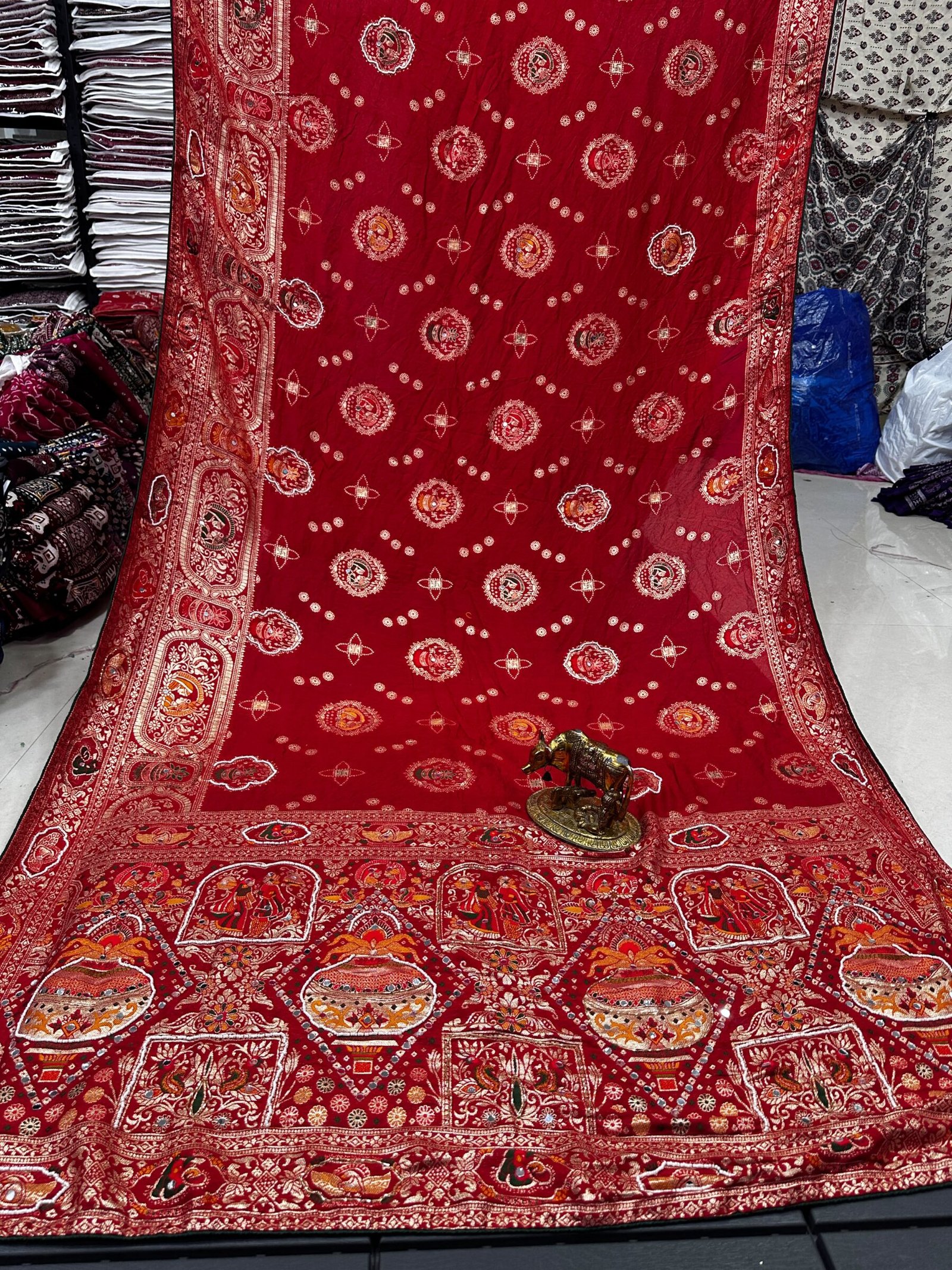Traditional Viscose Dolla Patola Saree - Karwa Chauth Special 10 A collection of beautiful Viscose Dolla Patola sarees in vibrant colours with traditional handwork and fancy latkans displayed on a textured background.