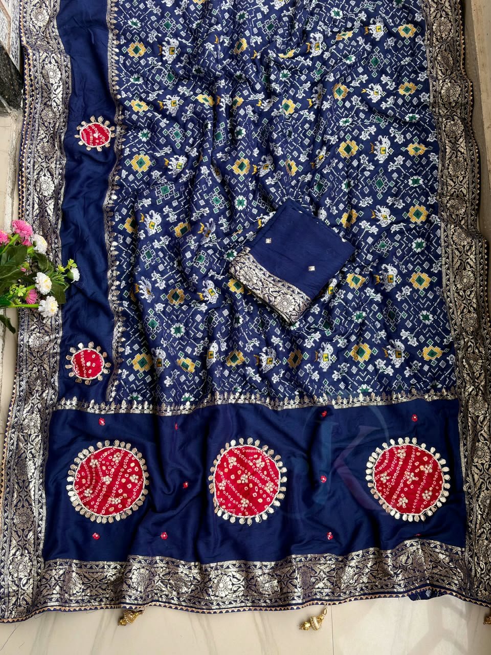 Traditional Viscose Dolla Patola Saree - Karwa Chauth Special 2 A collection of beautiful Viscose Dolla Patola sarees in vibrant colours with traditional handwork and fancy latkans displayed on a textured background.