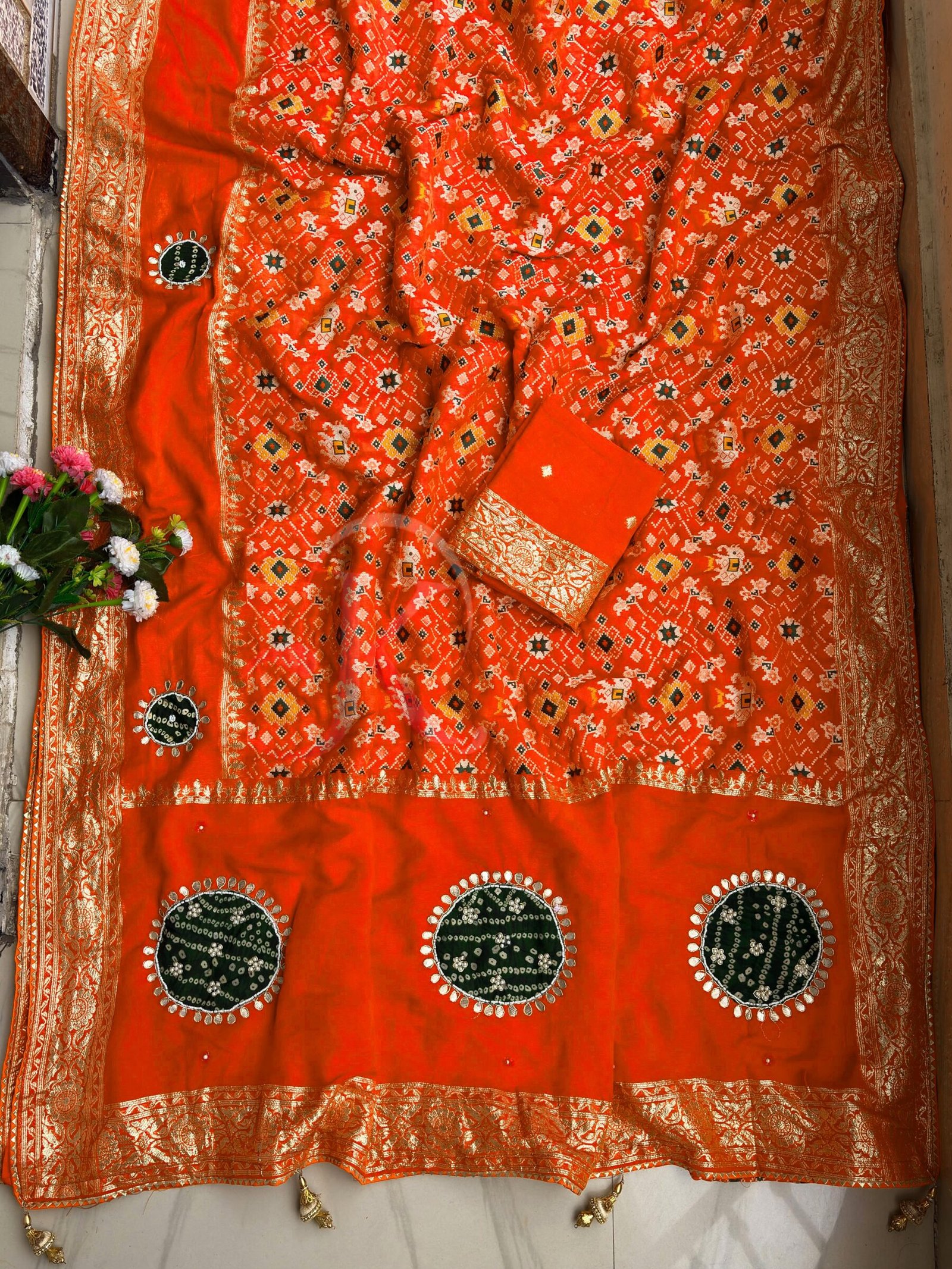 Traditional Viscose Dolla Patola Saree - Karwa Chauth Special 5 A collection of beautiful Viscose Dolla Patola sarees in vibrant colours with traditional handwork and fancy latkans displayed on a textured background.