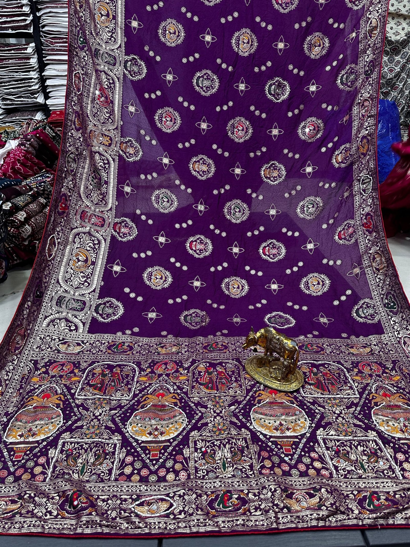 Traditional Viscose Dolla Patola Saree - Karwa Chauth Special 6 A collection of beautiful Viscose Dolla Patola sarees in vibrant colours with traditional handwork and fancy latkans displayed on a textured background.